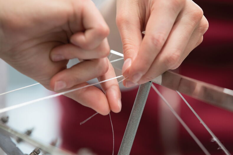 Hands holding threads